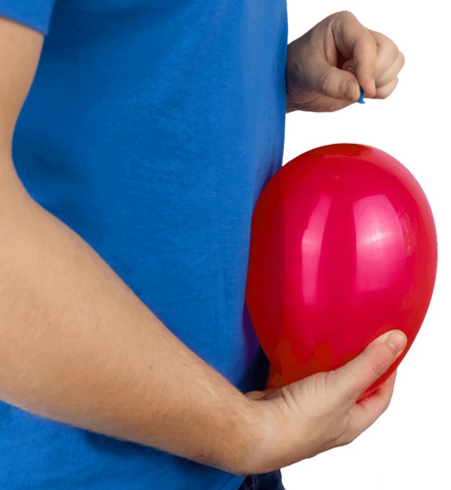 Man holding red balloon against his stomach, symbolising bloating and digestive discomfort