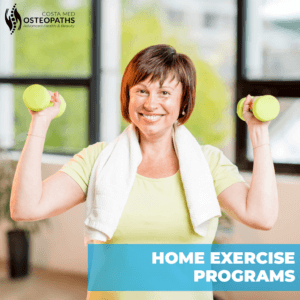 Smiling woman holding dumbbells during a home exercise routine for strength and well-being