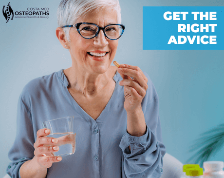 Smiling older woman holding a glass of water and a supplement capsule