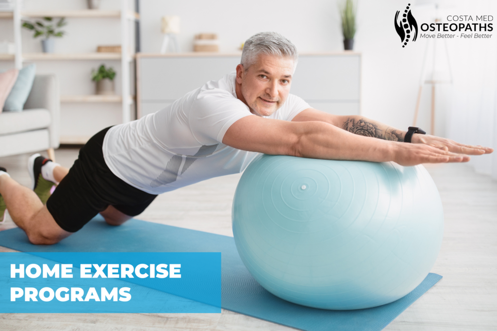 Mature man doing rehabilitation exercises at home with a stability ball on a yoga mat