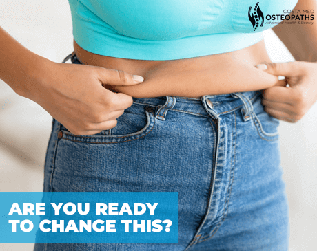 Close-up of a person pinching belly fat above jeans with the text: Are you ready to change this?